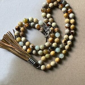 “It’s a Peppy” long necklace in shades of browns, tan and gold.